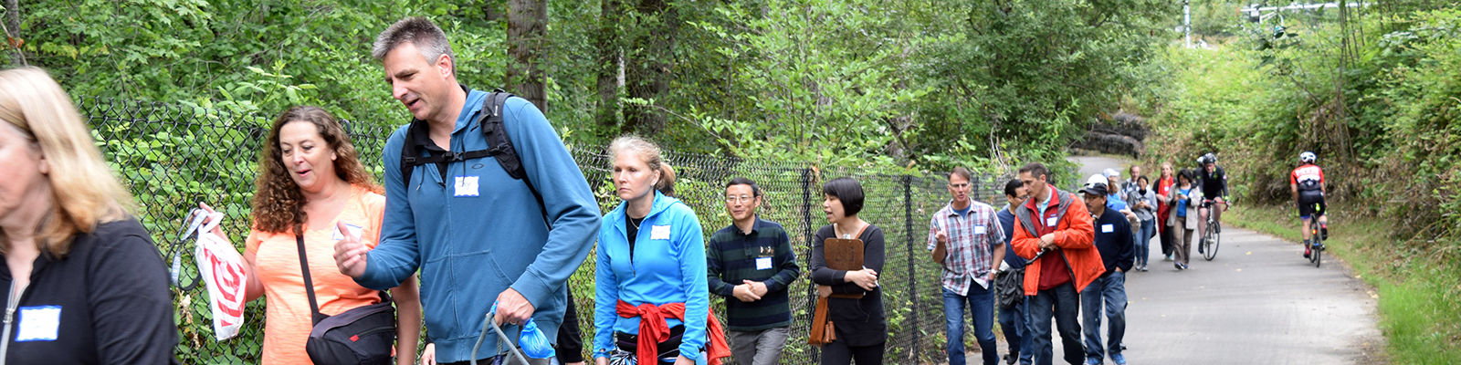 Residents and staff chat on a Neighborhood Walk in 2018.