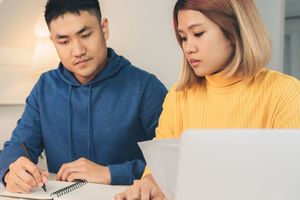 Picture of a man and woman paying bills