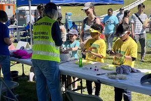 Volunteer helping kids with a craft