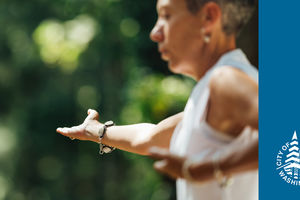 Tai Chi and Mindful Movement class. Image of a woman practicing Tai Chi. 