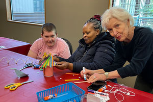 Highland Community Center volunteers and participants at arts and crafts table